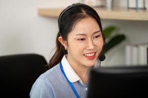 Customer Service Representative at Work. Engaged female agent smiling while assisting clients on a call. photo