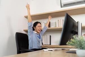 Excited Customer Service Agent. Female representative celebrating success after resolving client issues. photo