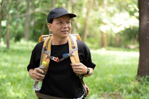 Outdoor Adventure. Hiker enjoying nature with backpack in lush green forest. photo