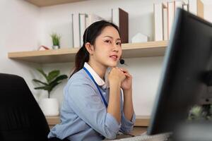 Focused Customer Service Representative. Female agent contemplating while assisting clients on a call. photo