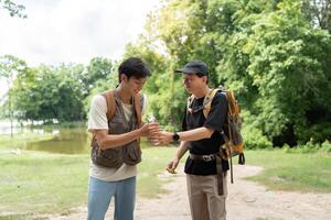 Father and Son Hiking Adventure. Two men enjoying nature while exploring a scenic trail. photo