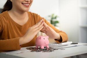 Protecting Savings. Woman safeguarding piggy bank with hands, emphasizing financial security. photo
