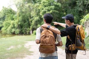 Father and Son Exploring Nature. Two men enjoying a scenic view while hiking. photo