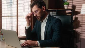Caucasian middle-aged business man typing laptop in office tired take off glasses eyes pain headache eye strain discomfort vision eyesight problem mature businessman working computer stress male job video