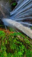 Epic FPV drone dive into powerful multi-stream Tumpak Sewu waterfall, deep green canyon, and lush rainforest in East Java, Indonesia. video