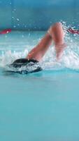 a person swimming in a pool with water splashing video