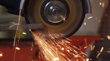 Grinding Metal With High-Speed Abrasive Wheel in Industrial Workshop, Close-Up of Sparks Flying From Blade Edge During Cutting or Finishing Process in video