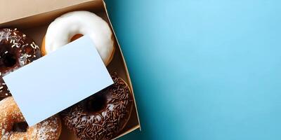 Assorted Donuts in Box with Blank Card Top View photo