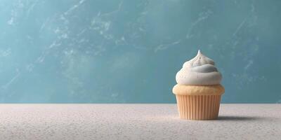Single Vanilla Cupcake with Cream Cheese Frosting on Beige Surface Teal Background photo