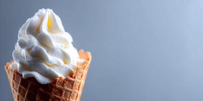 Closeup of Creamy Vanilla Soft Serve Ice Cream in Waffle Cone on Gray Background photo
