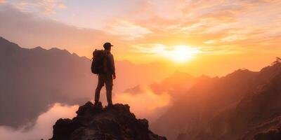 Hiker Silhouetted at Sunset Mountaintop View photo