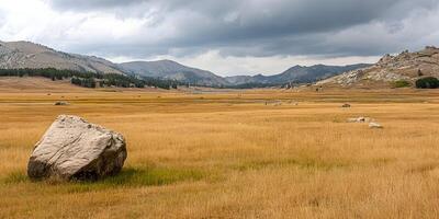 Autumnal Landscape Golden Grassland Mountains Stone Boulder Cloudy Sky photo