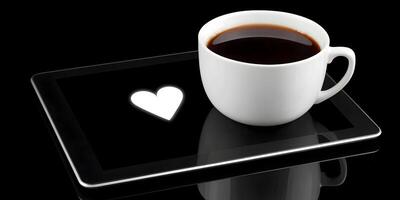 Black Coffee Mug on Tablet with White Heart Screen photo