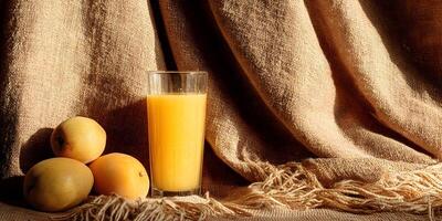 Glass of Orange Juice with Three Pears on Brown Fabric photo