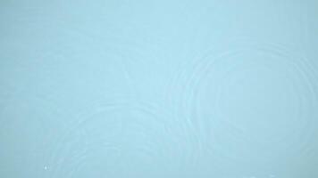 Water blue background. The movement of clearwater with rings and ripples. view of the water surface with various waves, drops and splashes. video