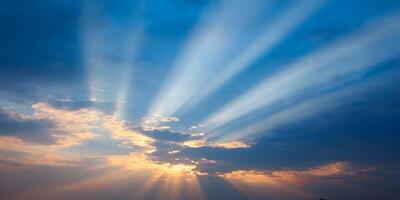 Sunset Sky with Crepuscular Rays Breaking Through Clouds photo
