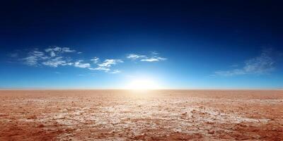 Red Clay Desert Landscape Under Blue Sky with Sun photo