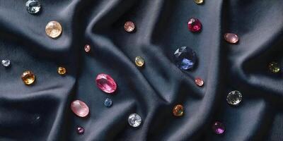 Assorted Gemstones on Dark Fabric Background Colorful Oval and Round Precious Stones photo