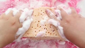 Hands are shaking a washcloth in soapy pink foam.. Asmr. Part 9 video