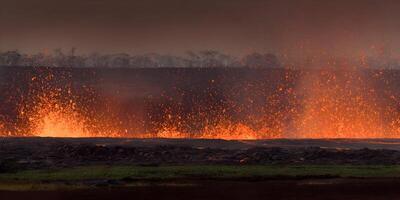 Volcanic Eruption Lava Flow with Sparks and Trees photo