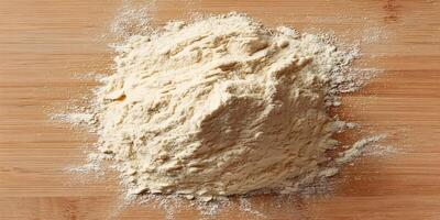 Pile of Light Brown Flour on Wooden Surface Top View Food Photography photo