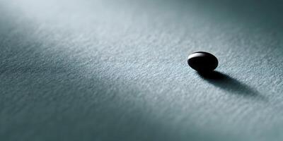 Single Dark Sphere on Teal Textured Surface Minimalist Photography photo
