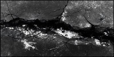 Black Cracked Surface with White Deposits Detailed Texture Image photo