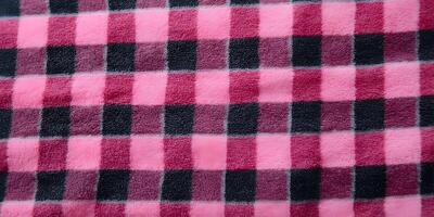 Pink and Black Checkered Fleece Fabric Texture Close Up photo