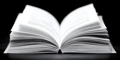 Open Book with Text Pages on Black Background Detailed Closeup Image photo