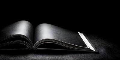 Open Black Book on Dark Surface Dramatic Low Key Lighting Photography photo