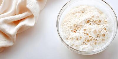 Oatmeal In Glass Bowl With Creamy Foam Bubbles Top View photo