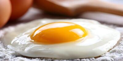 Fried Egg with Yolk Intact on Wooden Surface with Flour photo