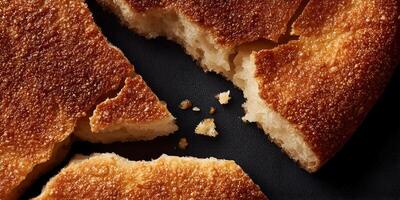 Closeup of Broken Pieces of Crusty Brown Bread on Dark Background photo