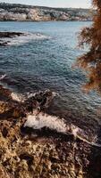 Beautiful and Serene Coastal View Captured Perfectly at Dusk During Sunset Hours. tranquil shoreline capturing essence of nature by sea, reflecting serene waters. vertical cinematic shot, film look video