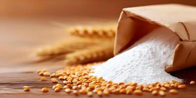 White Wheat Flour in Brown Paper Bag with Wheat Grains on Wooden Table photo