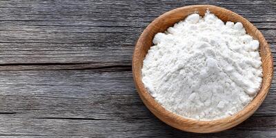 Wooden Bowl of White Flour on Rustic Wooden Table Top photo