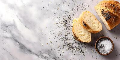 Sliced Artisan Bread with Everything Bagel Seasoning on Marble Background photo