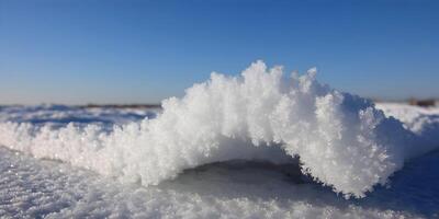 Closeup of Snowdrift Under Blue Sky Winter Snow Texture Frost Crystals photo