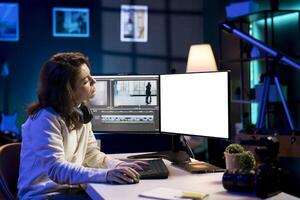 Videographer using professional software on mockup PC to create visual effects for projects. Expert using post production techniques to edit raw clips footage on isolated screen monitor photo