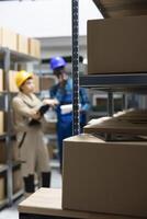 Employee oversees delivery processes and controlling inventory, checking boxes in a warehouse setting. Handling industrial workspace dedicated to product management and logistics solutions. photo