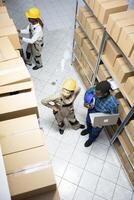 Supply chain warehouse operations possible by diverse staff to manage inventory and stock, organizing cargo goods and coordinating distribution in the logistics center storage room. photo