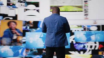 Young black professional explores a tech driven environment with visual data, content feeds and applications. Symbolizing entertainment, social reach and digital transformation. Camera A. video