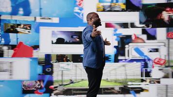 Confident black public speaker delivers guidance at a live event, presenting digital influence and e commerce at the convention. Social media feeds for web communication. Entertainment. Camera A. video