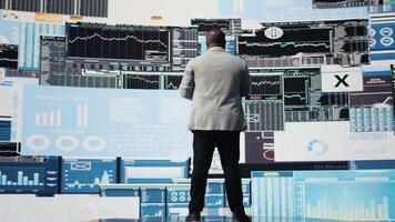 African american professional reviews financial charts and KPI projections, business performance and innovation with strategic insight through fintech materials and forecasting tools. Camera A. video