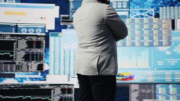 Modern black entrepreneur thinking about new powerful ideas to obtain funds, reviewing data insights for the financial and KPI projections decision making. Forecasting for productivity. Camera A. video