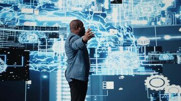 Black IT specialist working in cyberspace and AI brain tools for deep learning and neural networks systems, representing algorithmic thinking development. Big data visualization. Camera A. video