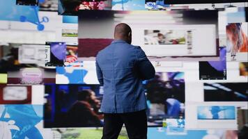 Black high tech person exploring digital world through web platforms, reflecting trends in social media, sharing and user interface design within online environment. Camera A. video
