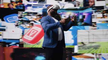 African american influencer using virtual reality glasses in mobile apps world, examining cloud data, visual content and emphasizing presence across tech platforms and social networks. Camera A. video