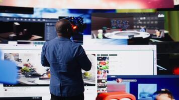 Black social media manager engaging with social network trends on screens, showcasing user interface and digital web platforms. Power of technology, influence and internet connection. Camera A. video