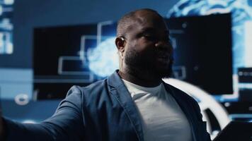 African american male specialist presenting deep learning AI systems, ensuring robotics for automation and neural networks brain innovation. Young professional presenter host. Camera B. video